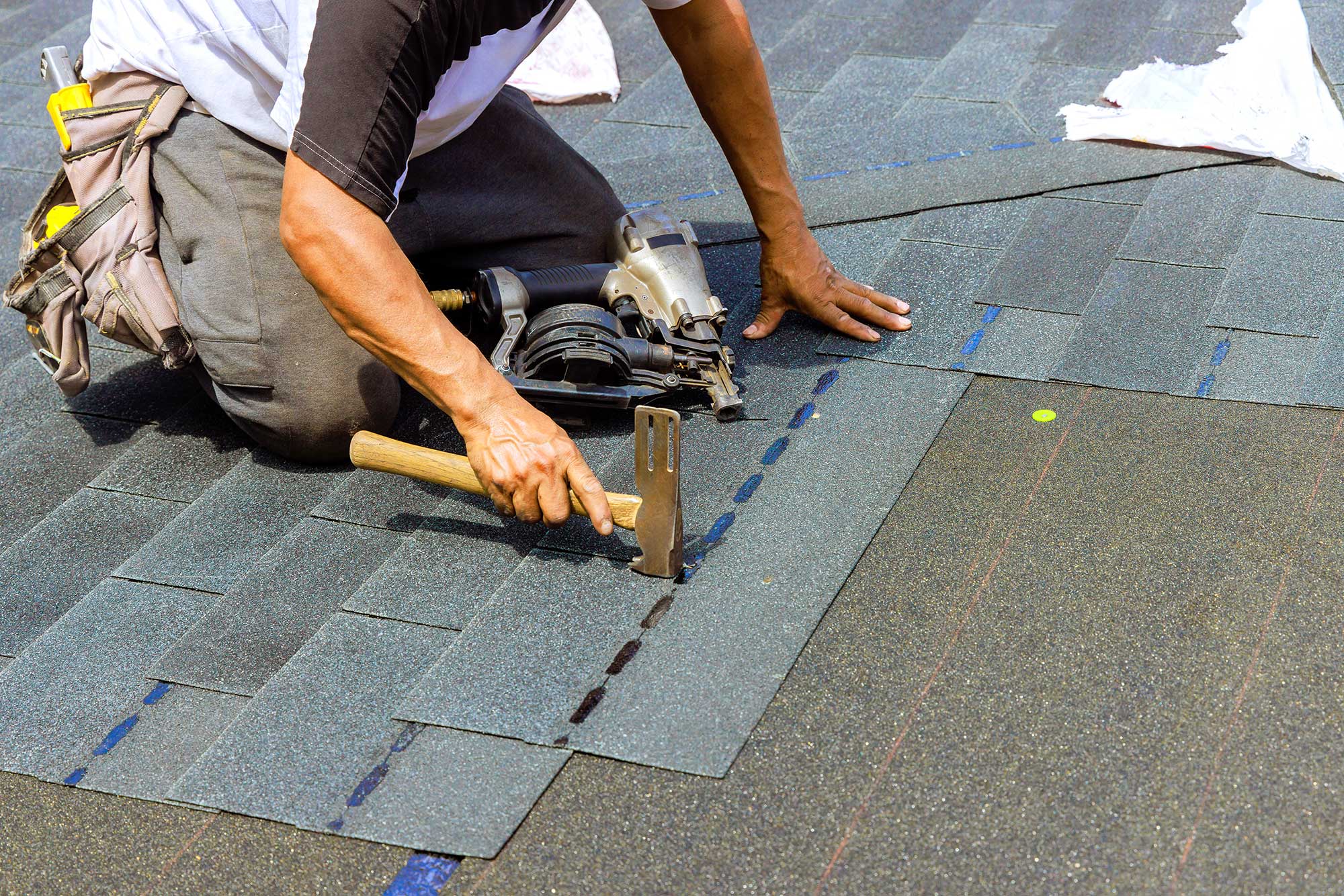 Professional roofers installing an asphalt shingle roof for a residential home.