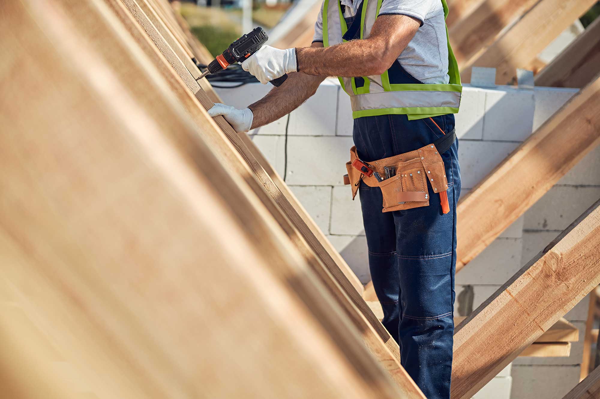 male-builder-drilling-in-the-wooden-frame