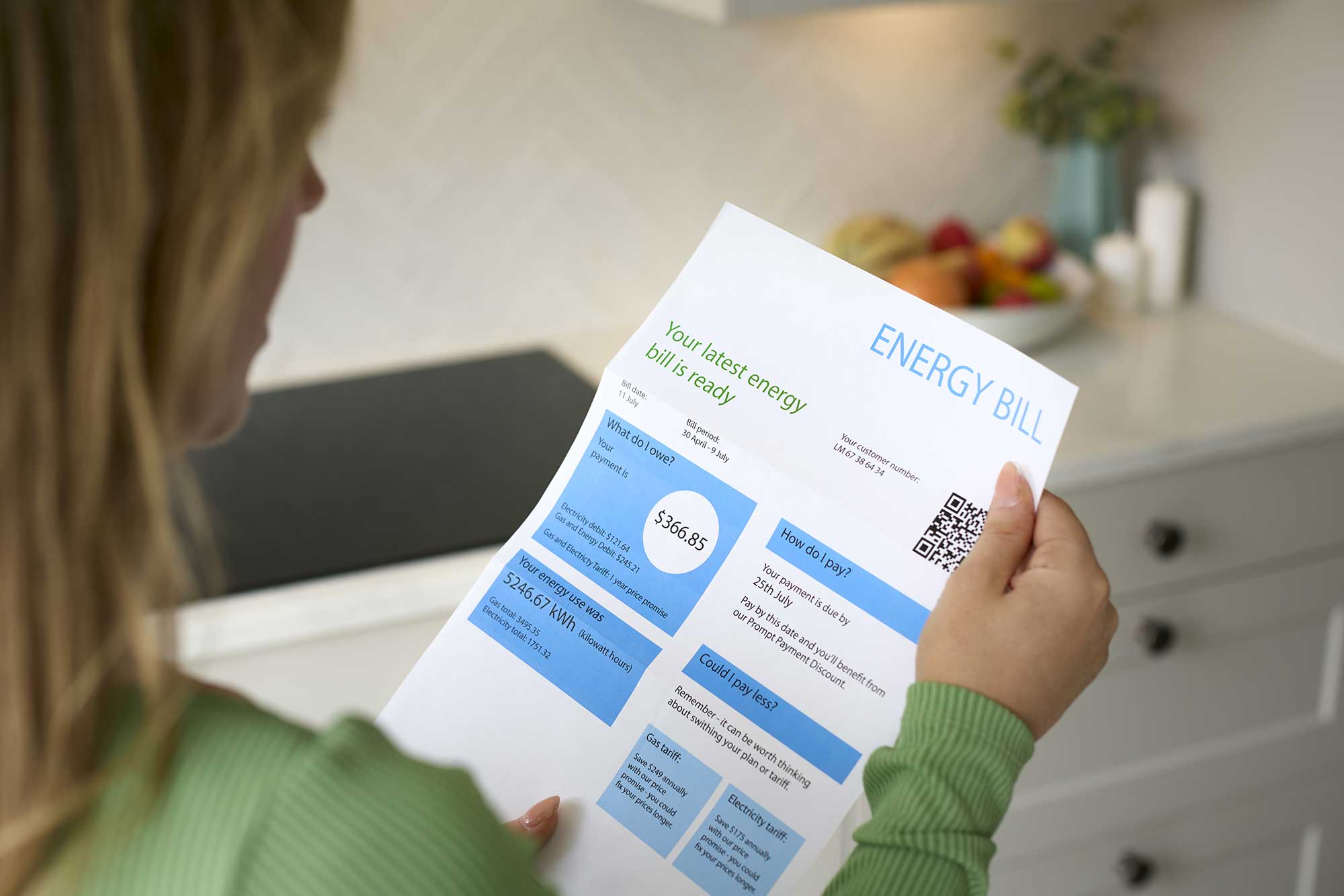 A homeowner reviewing increased energy bills due to poor roof insulation.