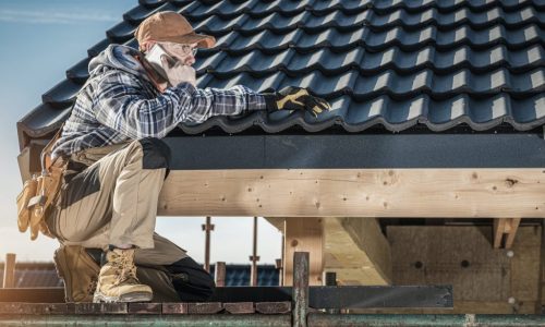 roof-construction-worker-making-phone-call-while-staying-on-scaffolding